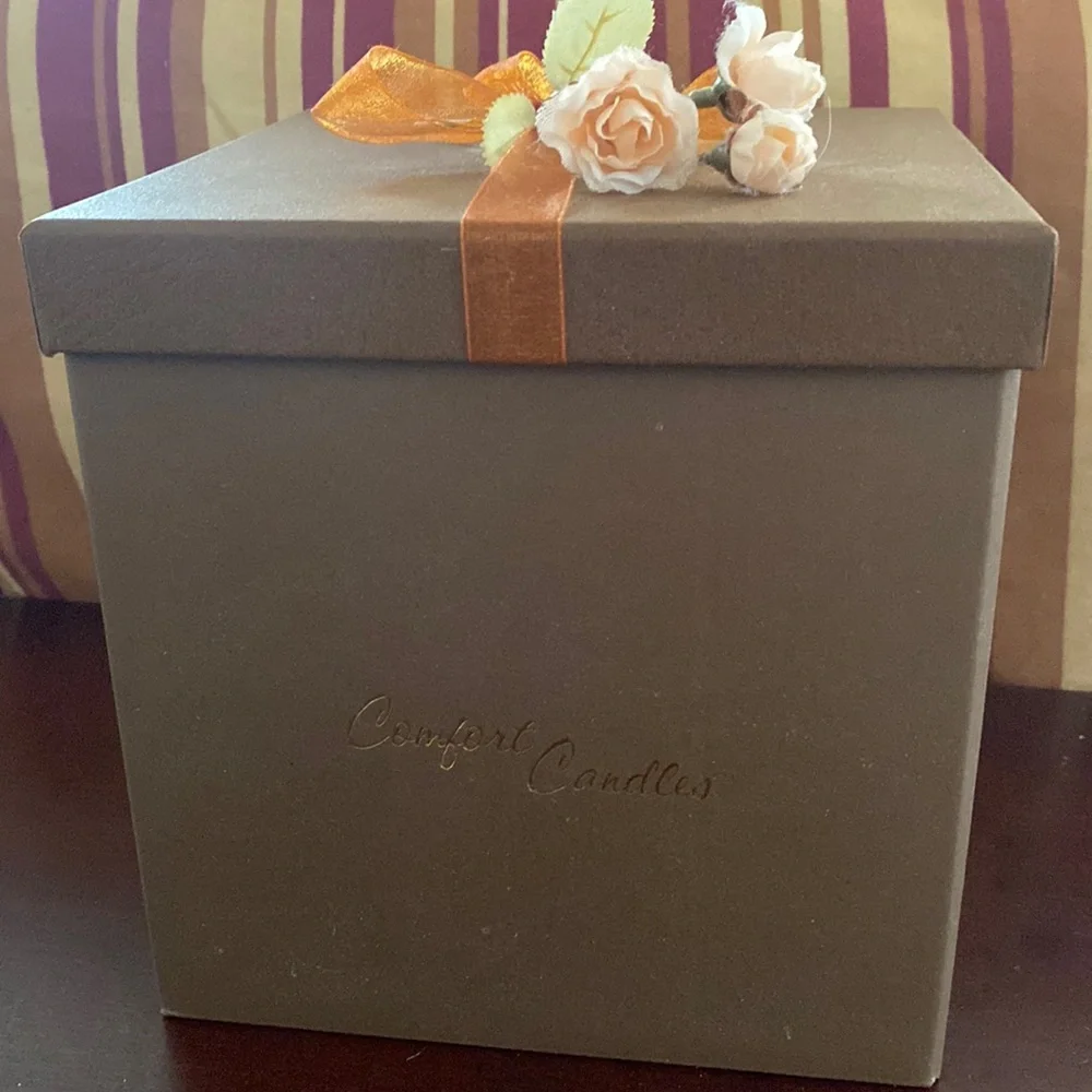 Pretty storage/gift box. Cardboard. Bronzish color with orange ribbon and flower